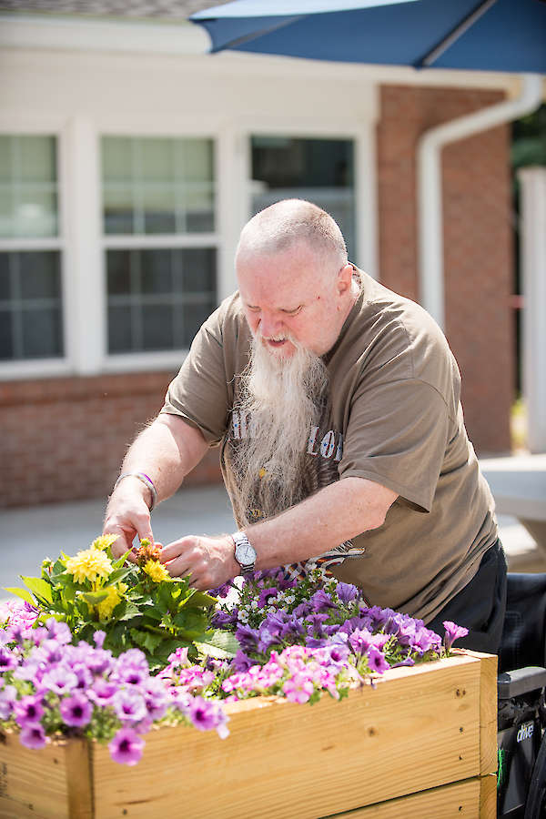 Amputee, Resident working in garden, gardening, flowers, activities, recreation, 60 West in Rocky Hill, CT